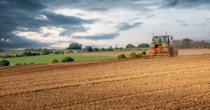 Farmer,Tilling,The,Land,On,His,Tractor,In,The,Fields
